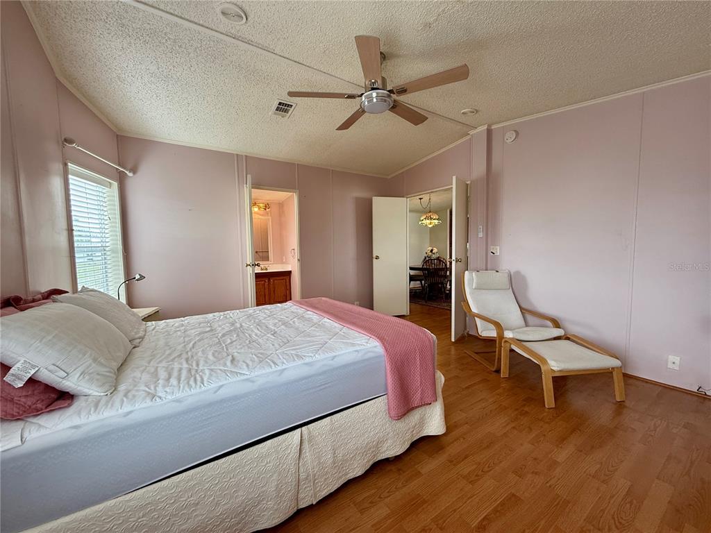 222 North St George Circle Apollo Beach, FL 33572 - Photo 14 of 33 a bedroom with a bed and a cabinets