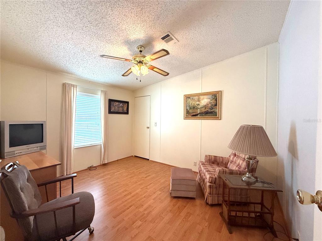 222 North St George Circle Apollo Beach, FL 33572 - Photo 16 of 33 a living room with furniture and a flat screen tv