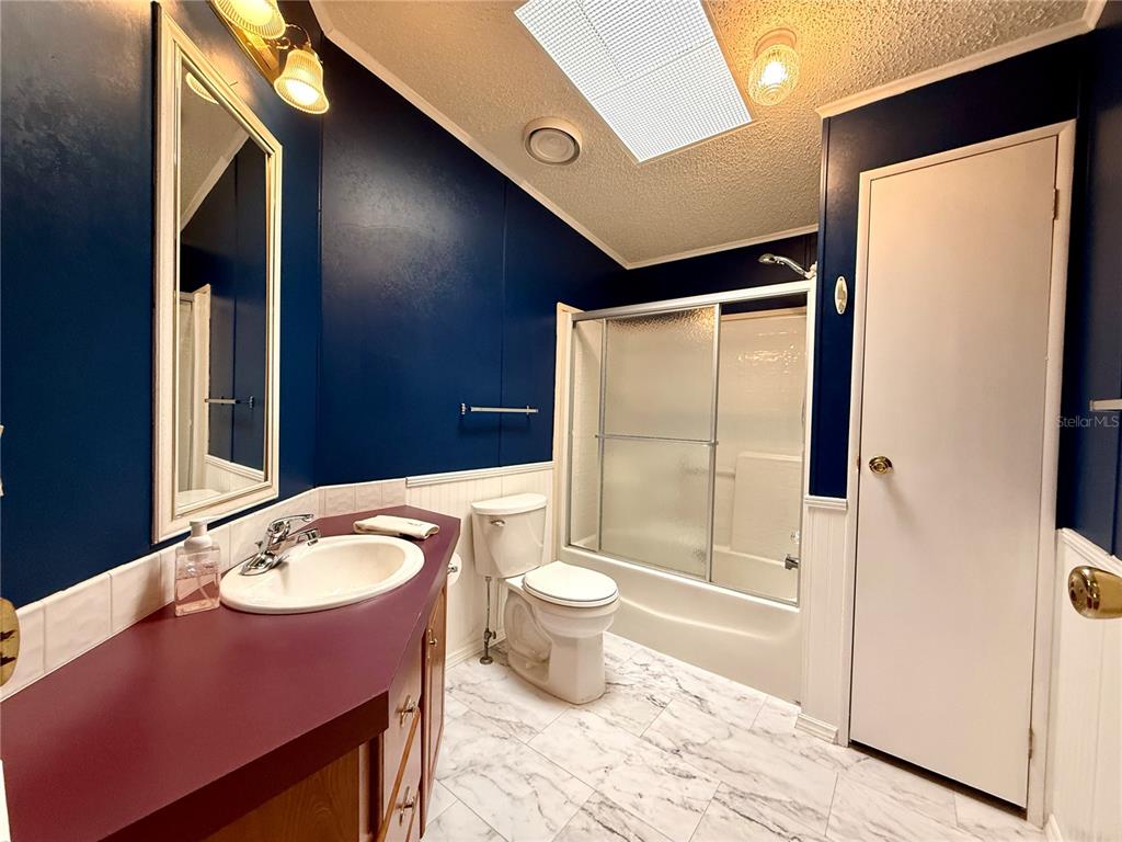222 North St George Circle Apollo Beach, FL 33572 - Photo 17 of 33 a bathroom with a granite countertop sink toilet and shower