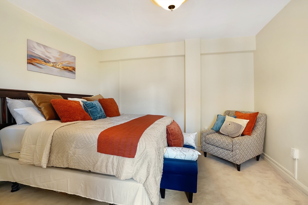 20 Chapel Street, Unit B801 Brookline, MA 02446 - Photo 12 of 16 a bedroom with two beds and a couch