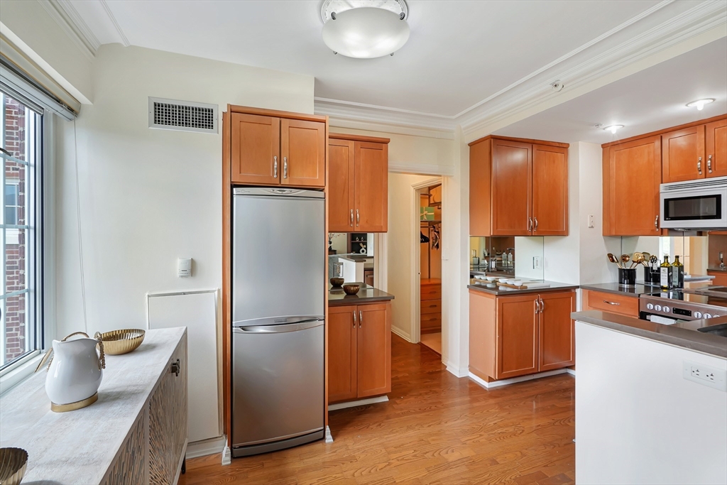 20 Chapel Street, Unit B801 Brookline, MA 02446 - Photo 6 of 16 a kitchen with stainless steel appliances granite countertop a refrigerator and a stove