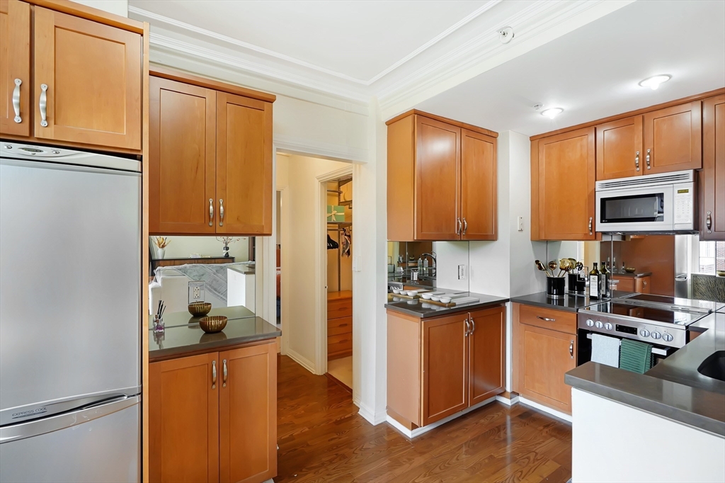 20 Chapel Street, Unit B801 Brookline, MA 02446 - Photo 7 of 16 a kitchen with stainless steel appliances granite countertop a refrigerator and a stove top oven