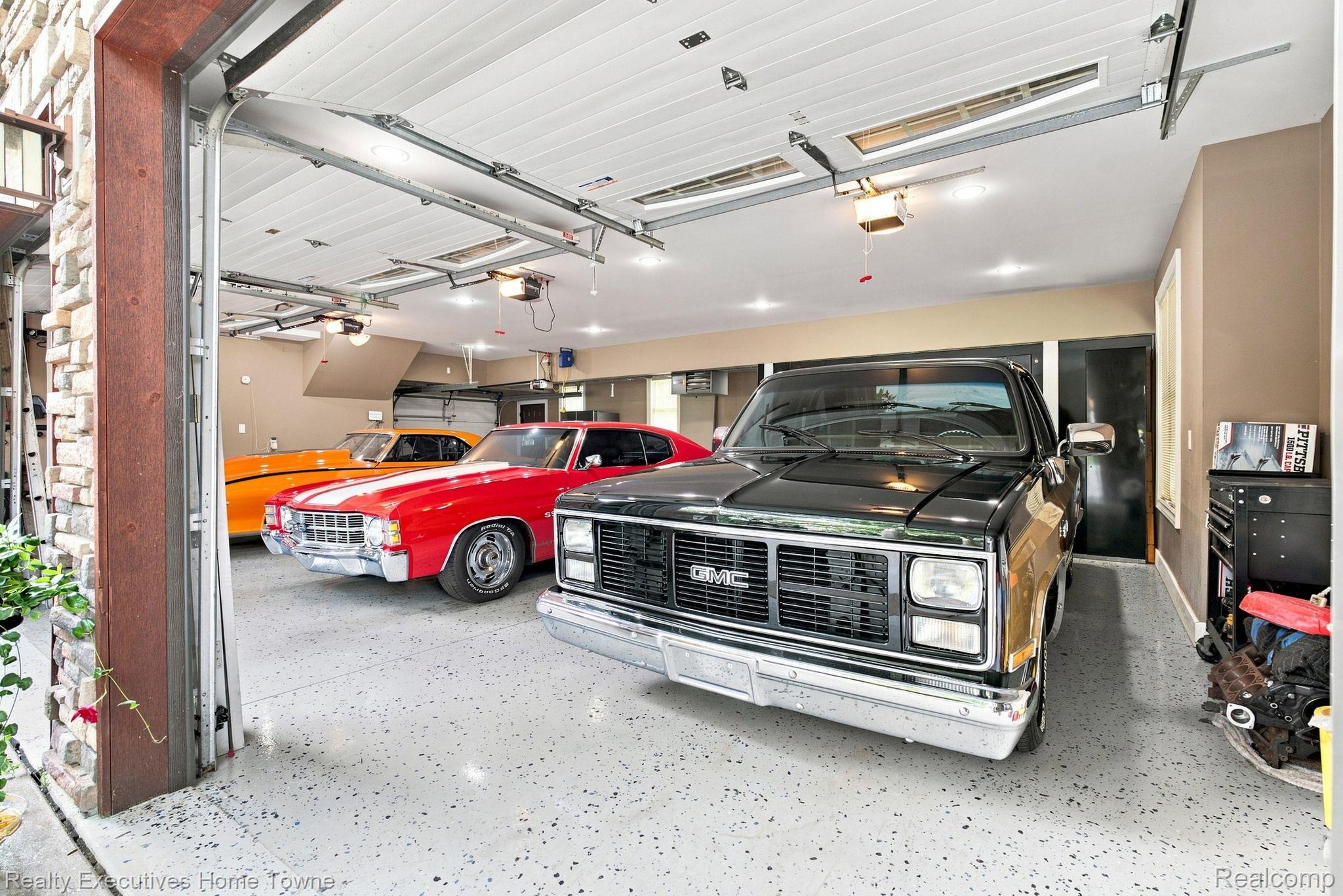 2829 Riverside Drive Port Huron, MI 48060 - Photo 83 of 99 Multi-car garage featuring segmented overhead doors, recessed lighting, and a textured epoxy floor