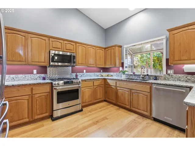 a kitchen with granite countertop a sink cabinets and window