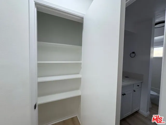 a view of walk in closet with empty racks