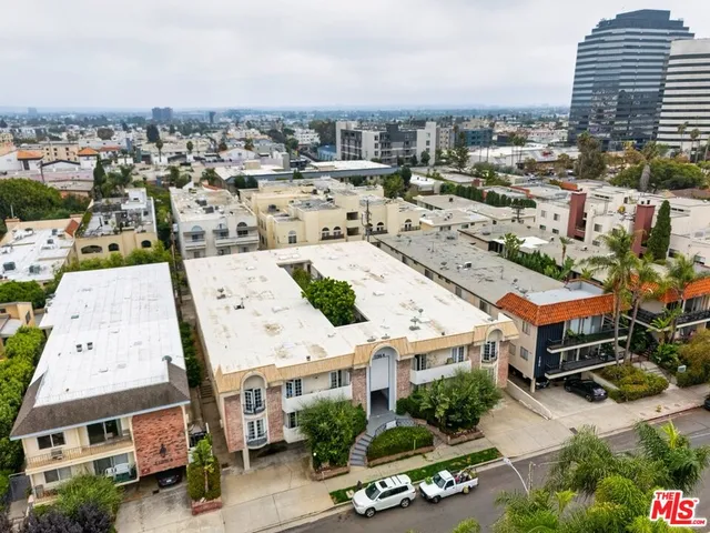 an aerial view of residential houses with yard