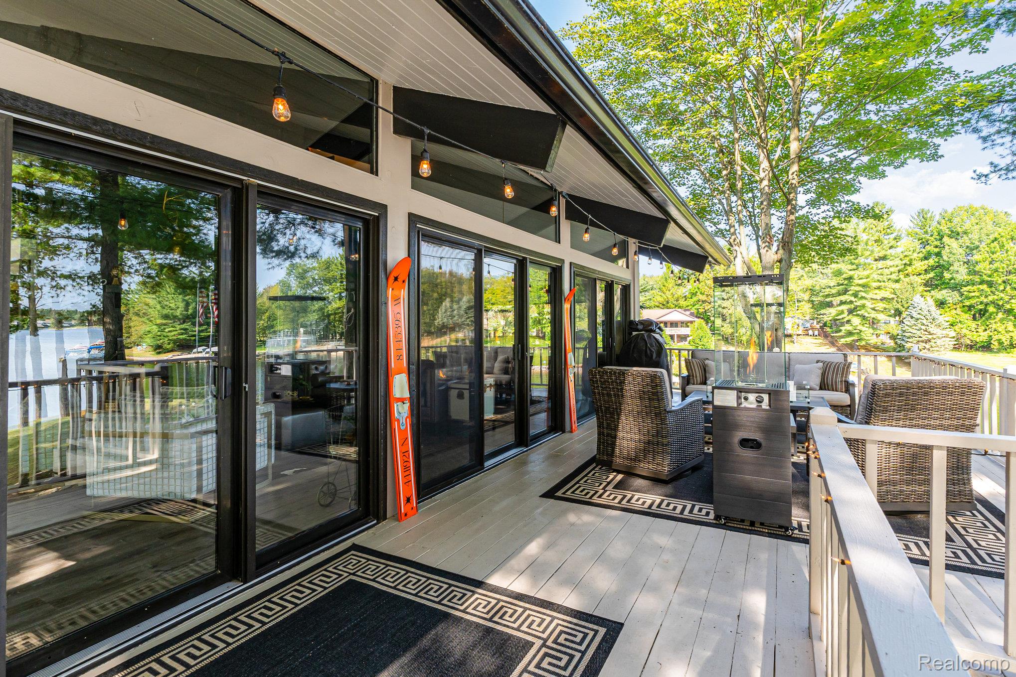 2380 Islanders Way Gladwin, MI 48624 - Photo 17 of 48 Wooden terrace featuring an outdoor living space with a fire pit