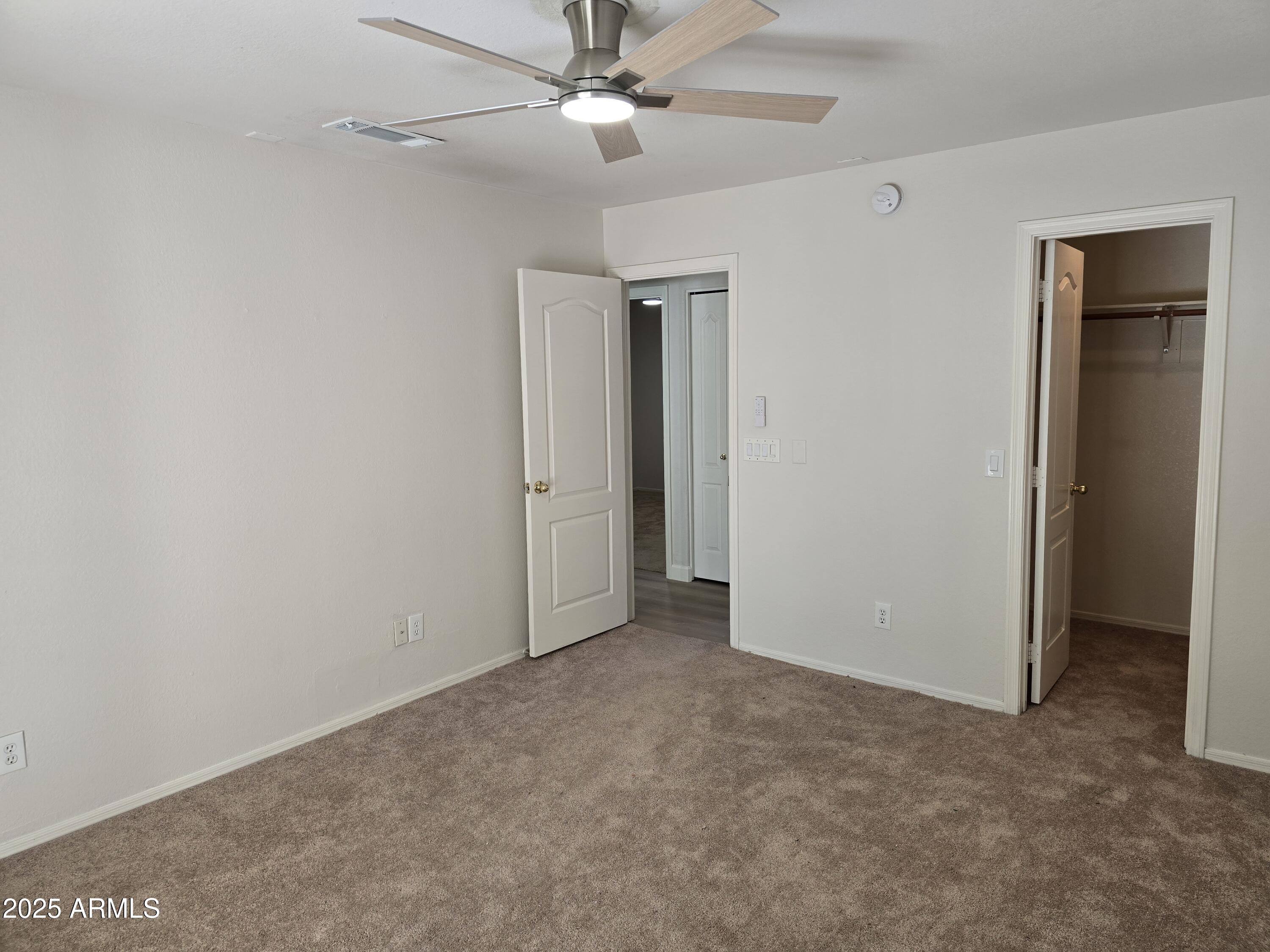 1443 West 14th Avenue Apache Junction, AZ 85120 - Photo 11 of 21 an empty room with closet and a ceiling fan