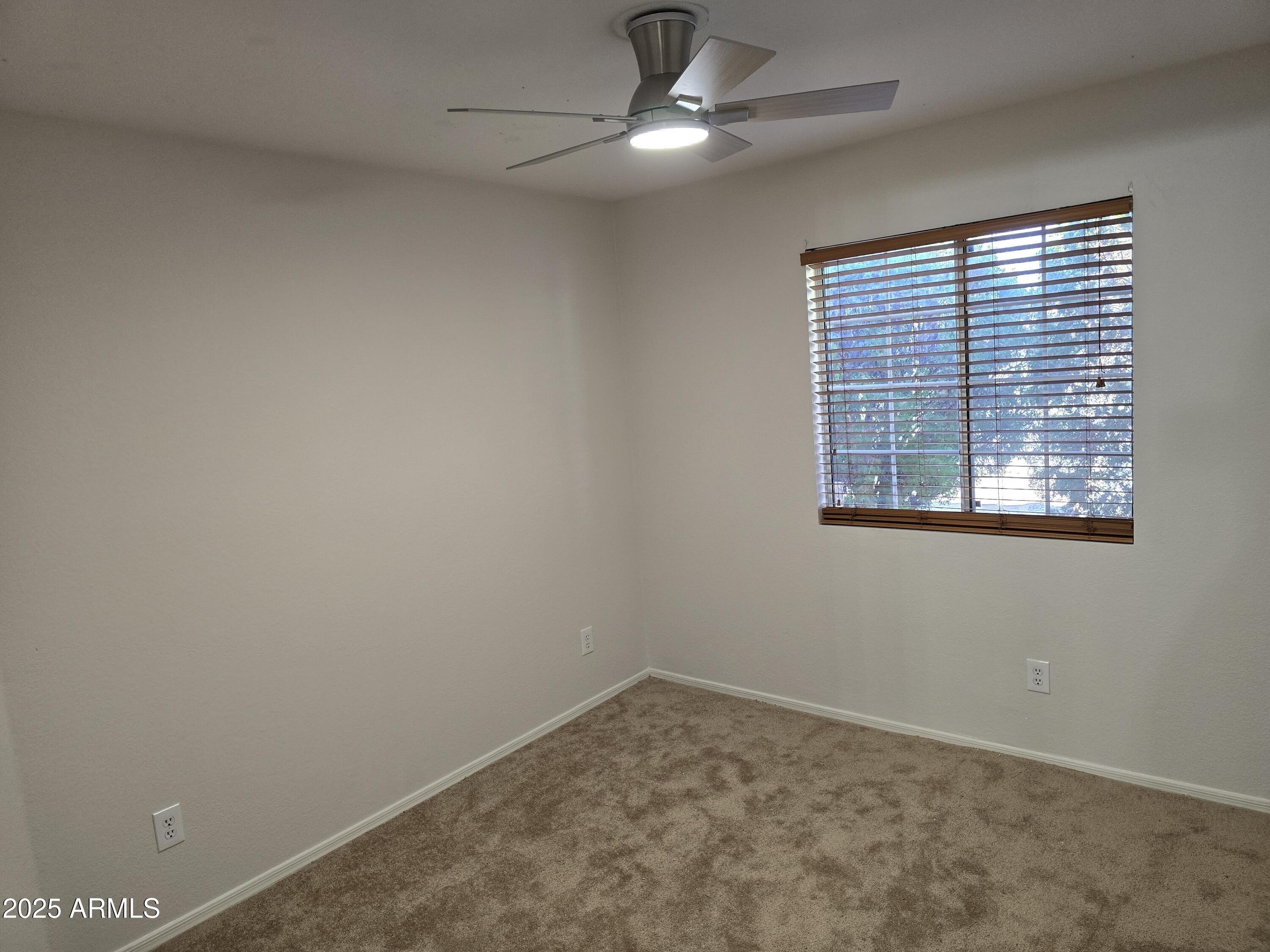 1443 West 14th Avenue Apache Junction, AZ 85120 - Photo 6 of 21 an empty room with a window