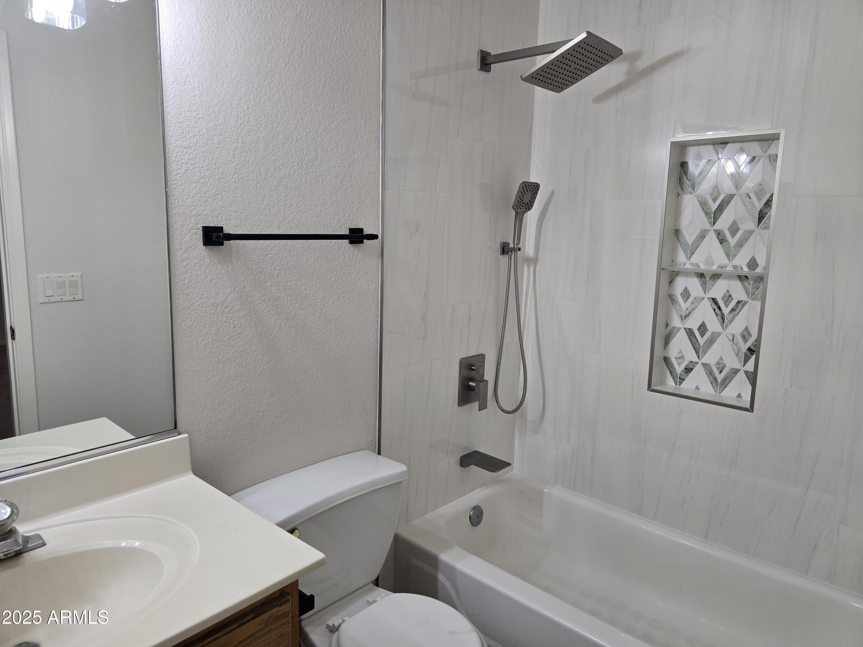 1443 West 14th Avenue Apache Junction, AZ 85120 - Photo 7 of 21 a bathroom with a sink toilet and shower