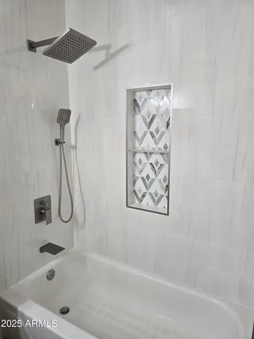 a bath tub sitting next to a shower
