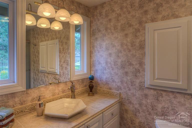 60192 West Ridgeview Drive Bend, OR 97702 - Photo 17 of 25 a bathroom with a granite countertop sink and a mirror