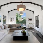 a living room with furniture fireplace and a large window
