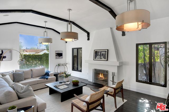 a living room with furniture fireplace and window