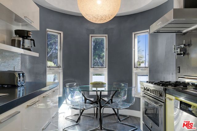 a kitchen with a stove and a refrigerator