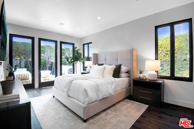 a bedroom with a large bed and a large window