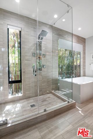a bathroom with a tub and shower