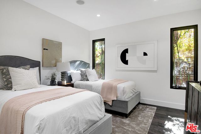 a bedroom with two beds and a window