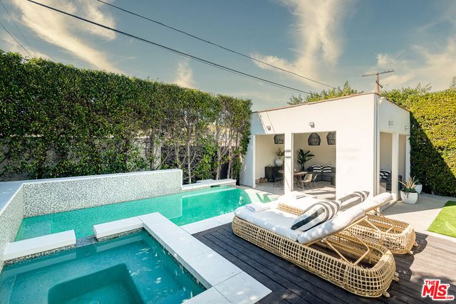 a view of a patio with couches table and chairs with garden view