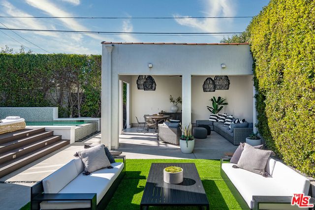 a view of backyard with outdoor seating and green space