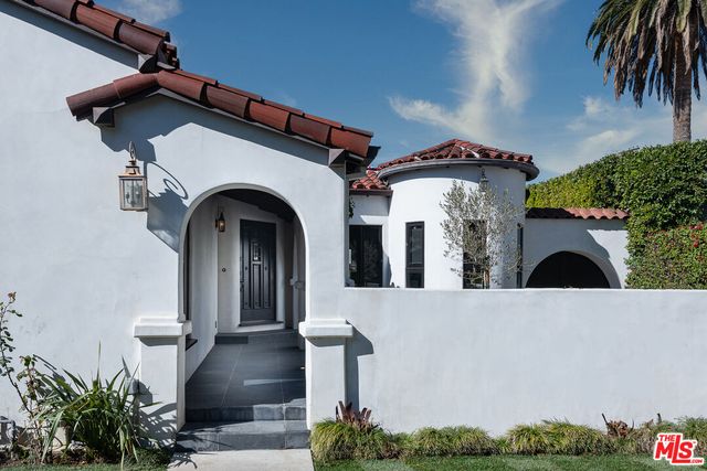 a view of a building with potted plants