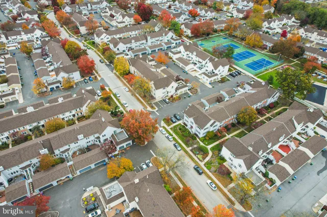 an aerial view of a house with a yard and garden