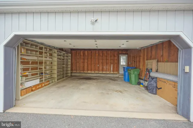 a view of a bedroom with wooden floor and windows