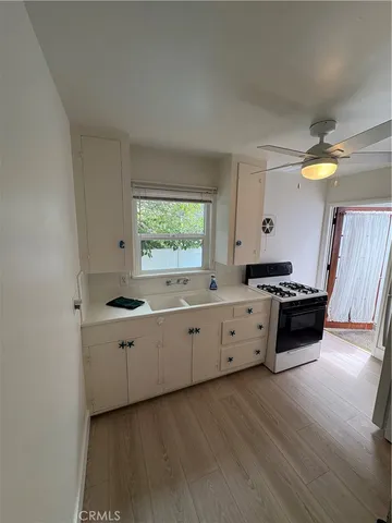 a kitchen with stainless steel appliances a stove a sink and a refrigerator