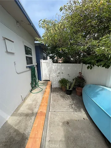 a view of backyard with outdoor seating and plants