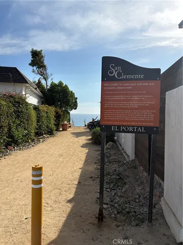 a sign board with building in the background