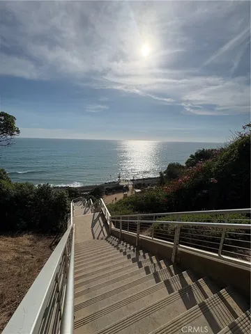 a view of roof deck with two chairs and wooden floor