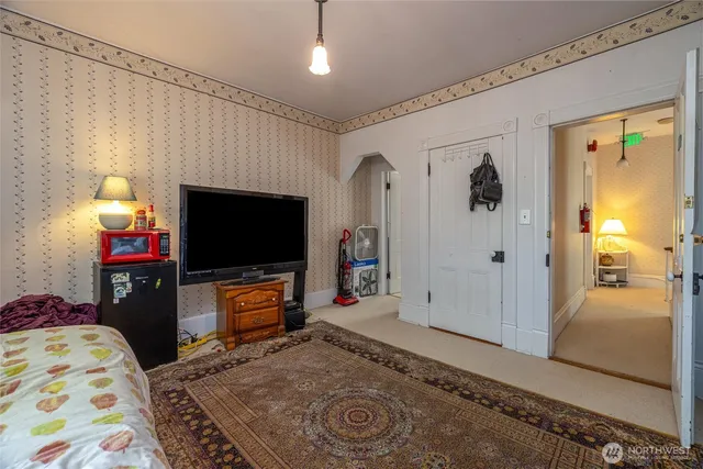 a living room with a bed furniture and a window