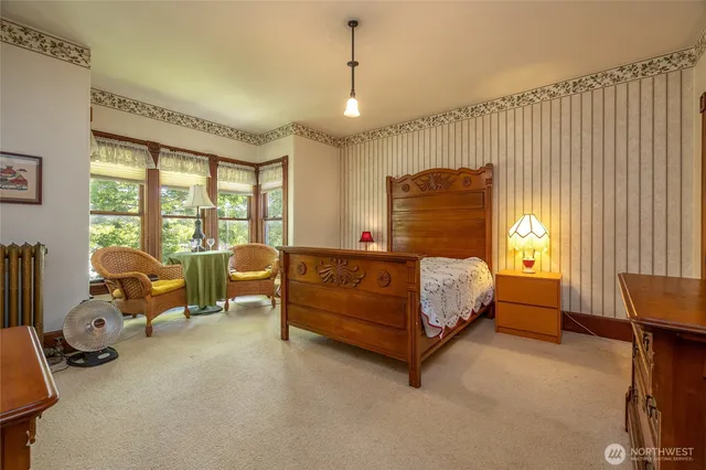 a bedroom with a large bed and a large window