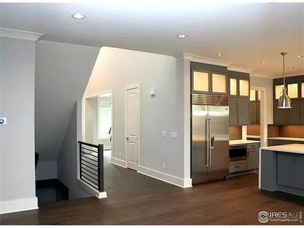a view of a hallway with staircase and white walls