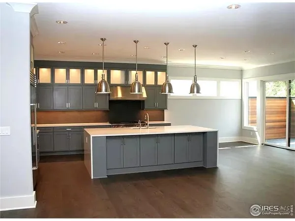 a view of kitchen with stainless steel appliances granite countertop a refrigerator and a sink