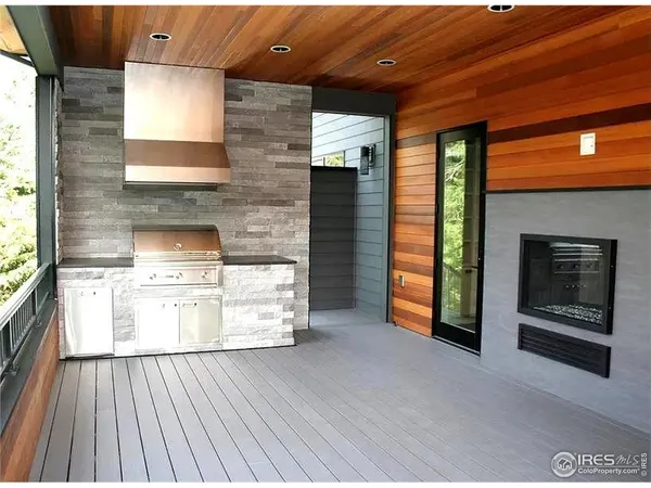 an empty room with windows and fireplace