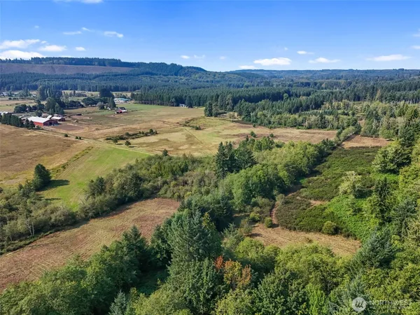 an aerial view of residential houses with outdoor space and river