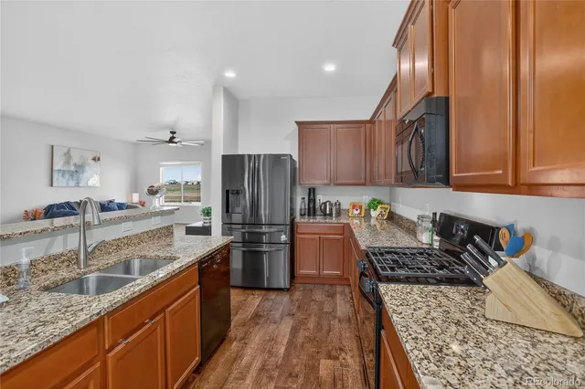 a kitchen with a refrigerator a sink and wooden cabinets