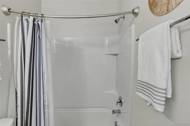 a bathroom with a shower and a tub