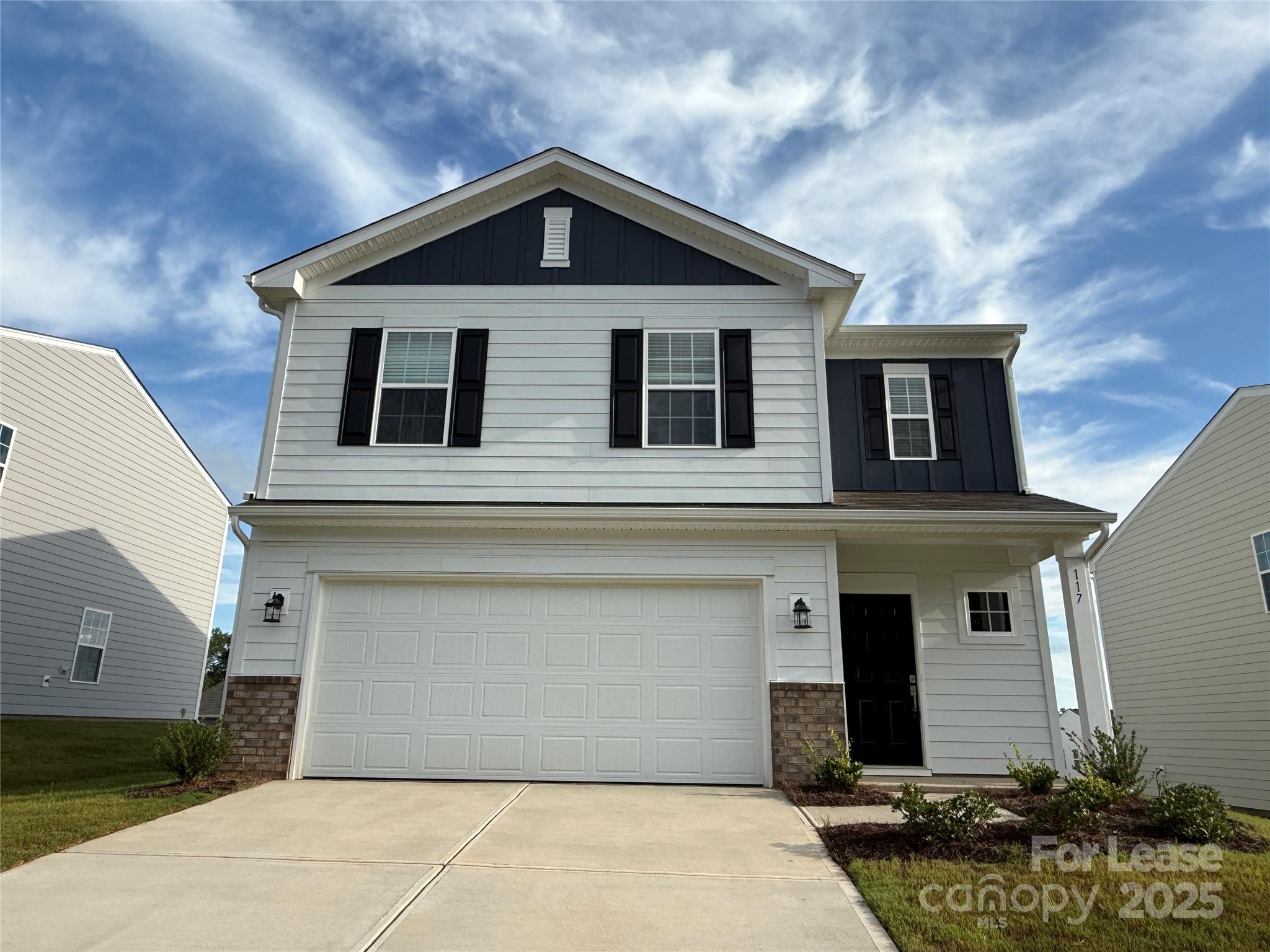 a front view of a house with garage