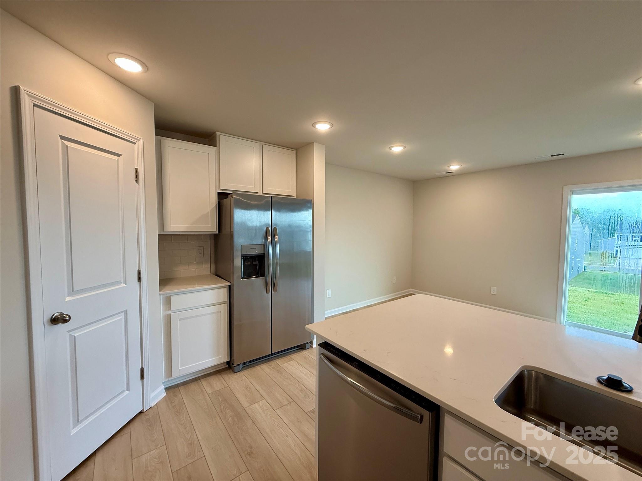 117 Dorian Place Troutman, NC 28166 - Photo 13 of 31 a kitchen with stainless steel appliances a refrigerator and a sink