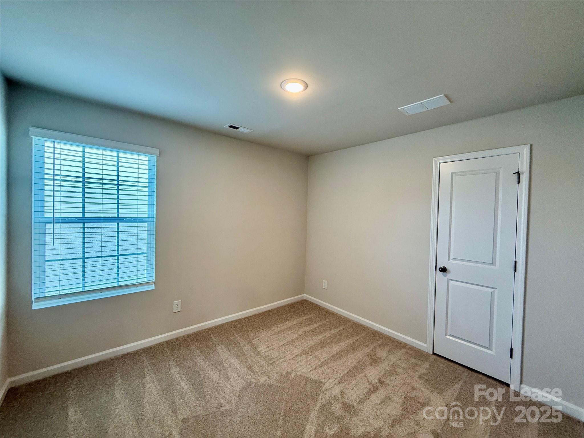 117 Dorian Place Troutman, NC 28166 - Photo 19 of 31 an empty room with windows