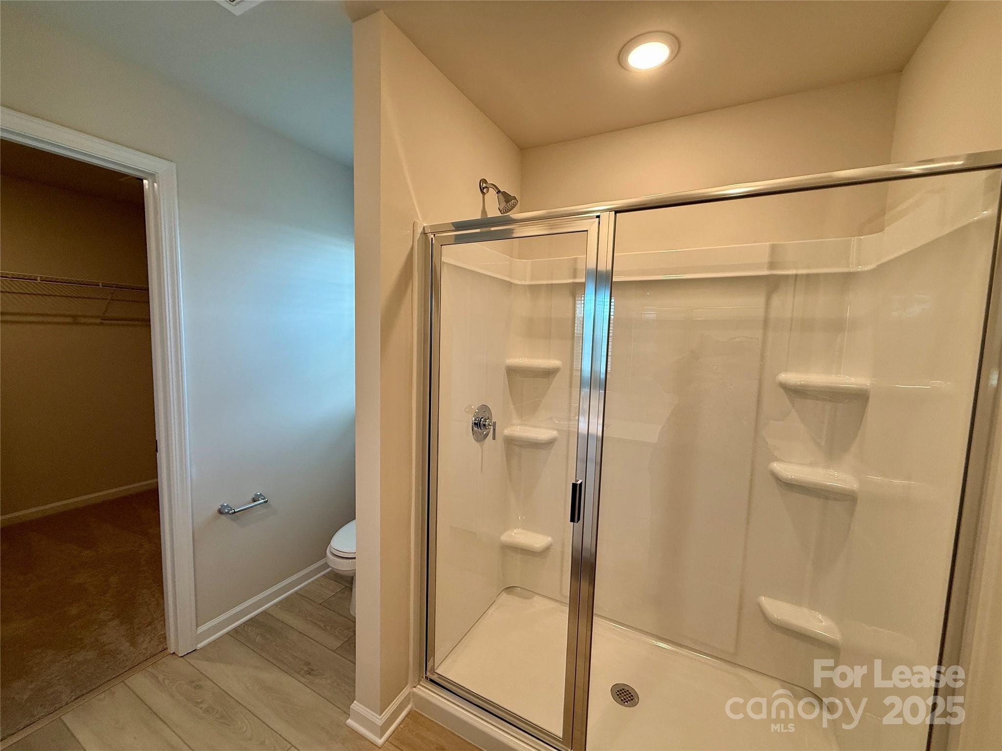 117 Dorian Place Troutman, NC 28166 - Photo 28 of 31 a bathroom with a glass shower door