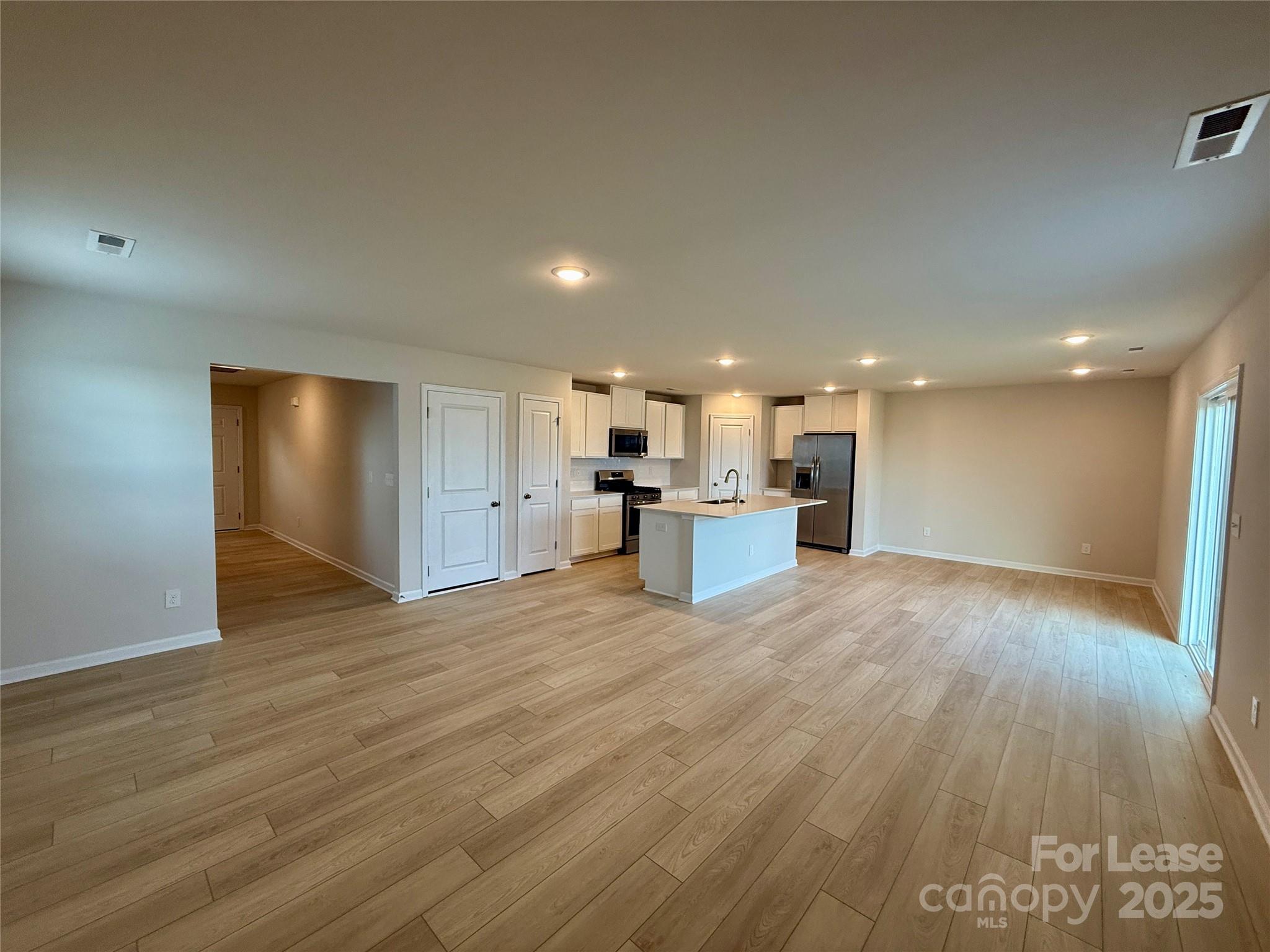 117 Dorian Place Troutman, NC 28166 - Photo 7 of 31 a view of kitchen livingroom with wooden floor