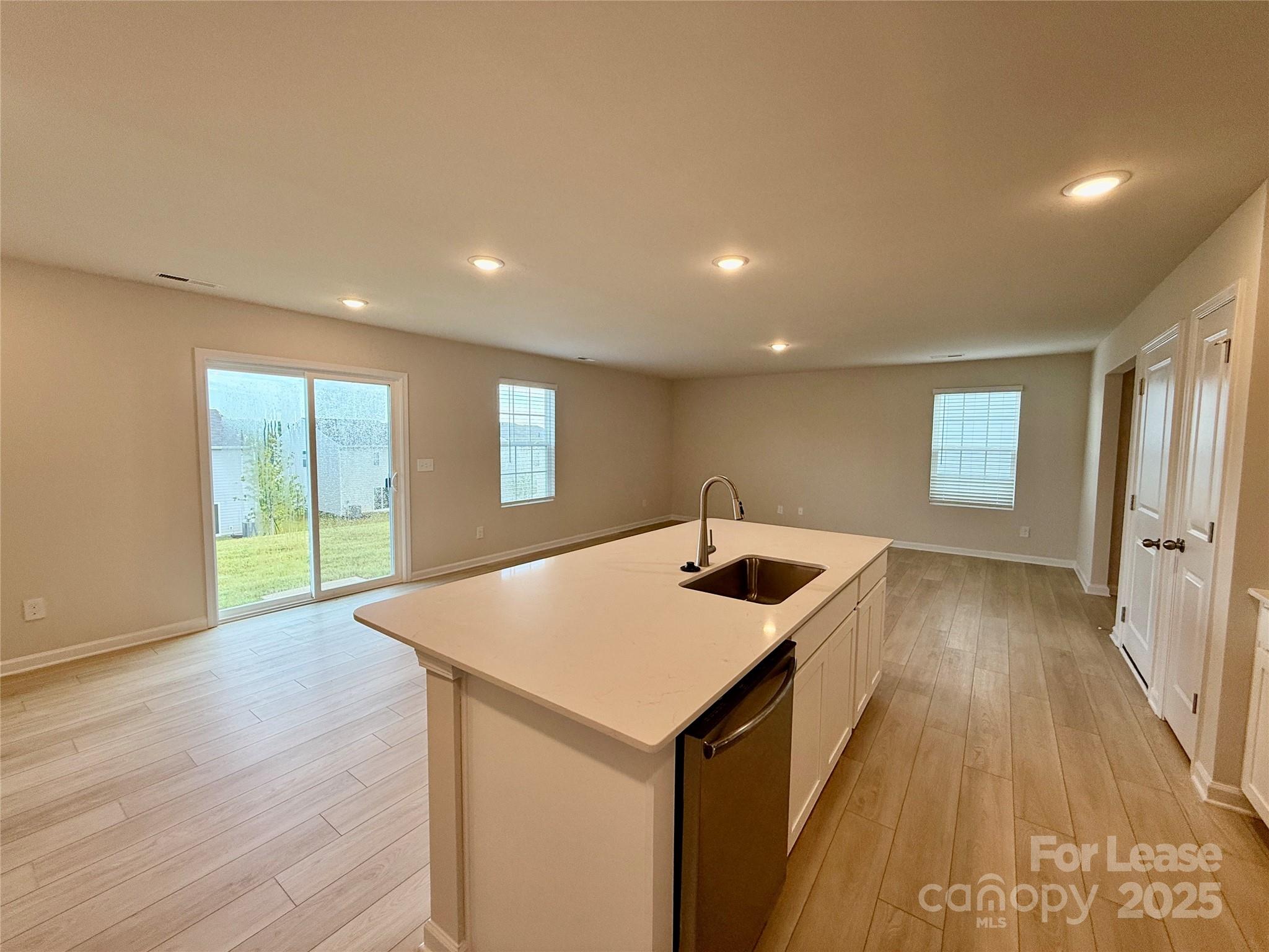 117 Dorian Place Troutman, NC 28166 - Photo 9 of 31 a kitchen with a sink and wooden floor