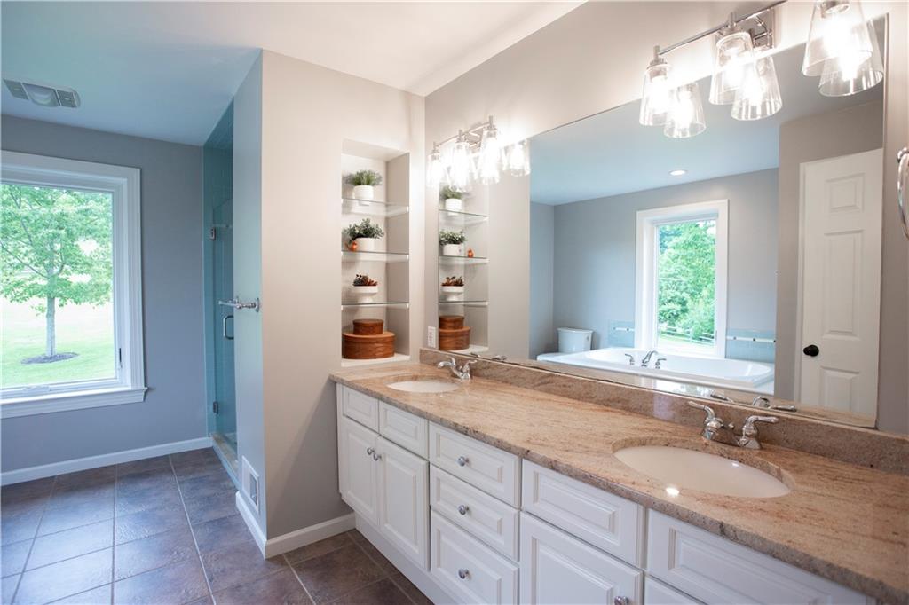 255 Camp Run Road Harmony, PA 16037 - Photo 24 of 49 a bathroom with a granite countertop double vanity sink a mirror and a shower