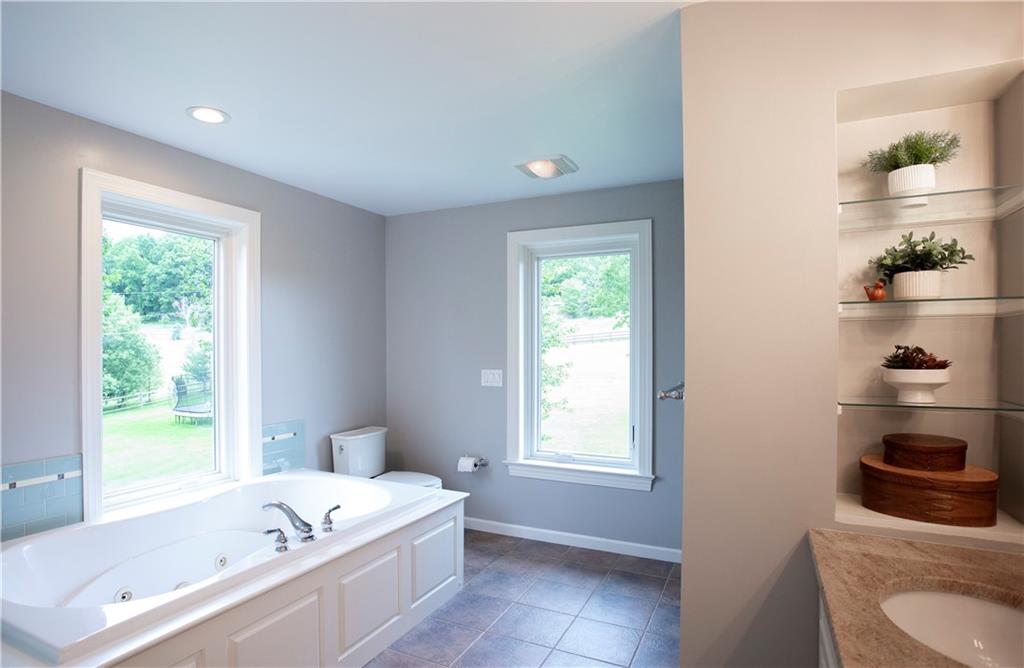 255 Camp Run Road Harmony, PA 16037 - Photo 25 of 49 a bathroom with a tub a sink and a window