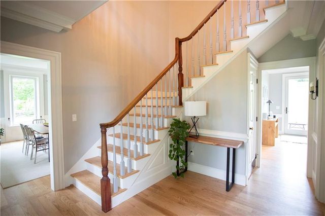 a view of entryway with wooden floor and stairs