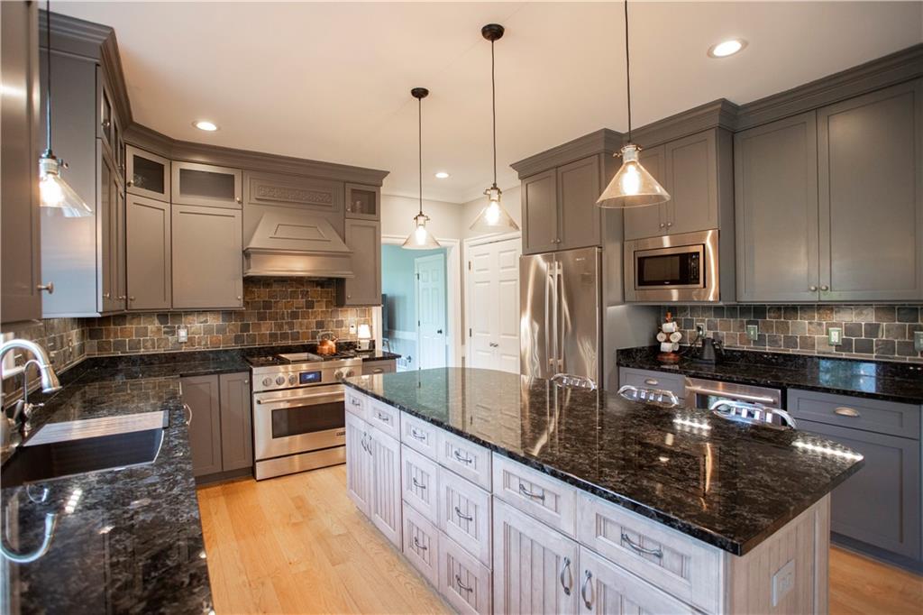 255 Camp Run Road Harmony, PA 16037 - Photo 9 of 49 a kitchen with stainless steel appliances granite countertop a sink a stove and a refrigerator