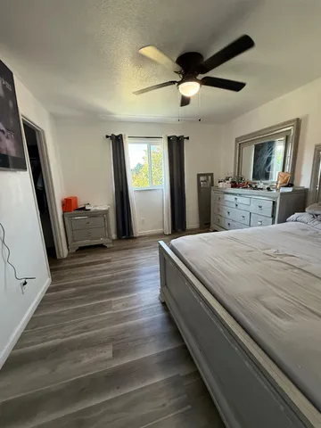 a bedroom with a bed and a large mirror